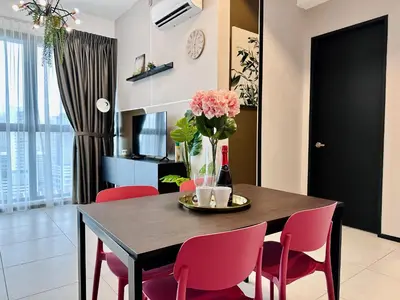 a dining room table with pink chairs and a vase of flowers at New 2BR or 3BR Cozy Urban Suite Homestay at Georgetown8-10pax by URBAN STAYCATIONS LOD COSY in Jelutong
