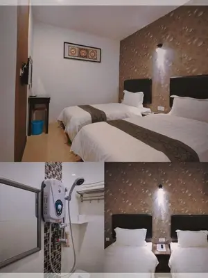 a hotel room with two beds and a tv at Inn Residence 18 in George Town