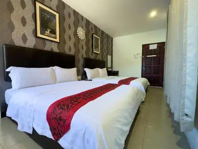a bedroom with a large white bed with a red blanket at Inn Residence 18 in George Town