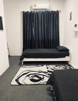 a room with two beds and a black curtain at AK Greenrise Meru in Ipoh