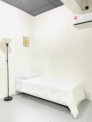 a white room with a bed and a lamp at AK Greenrise Meru in Ipoh