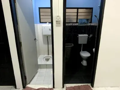 a bathroom with a toilet and a sink at Manjung Cozy Homestay in Sitiawan