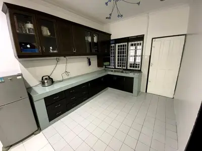 a kitchen with brown cabinets and a white tile floor at Manjung Cozy Homestay in Sitiawan