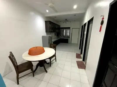 a kitchen with a table with a hat on it at Manjung Cozy Homestay in Sitiawan