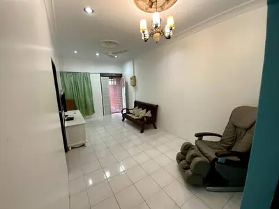a living room with a chair and a couch at Manjung Cozy Homestay in Sitiawan