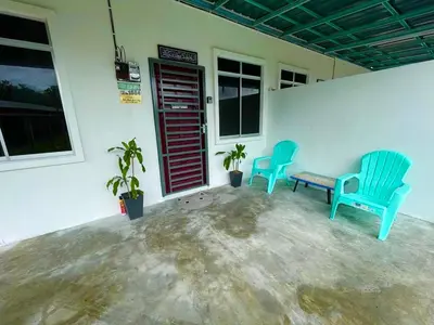 two blue chairs and a bench in a room at Tok Abah Homestay Bukit Mertajam in Bukit Mertajam