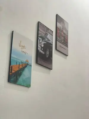 a group of pictures hanging on a wall at Tok Abah Homestay Bukit Mertajam in Bukit Mertajam