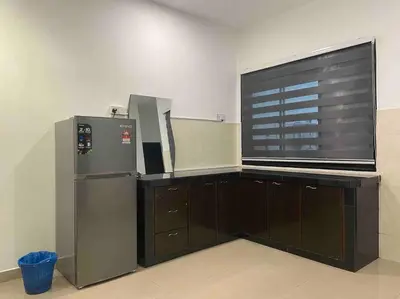 a kitchen with a refrigerator and a large window at Warm and Cozy in Teluk Intan