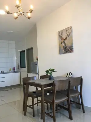a dining room table and chairs in a kitchen at New! Batu Ferringhi Seaview Cozy Condo, Penang in Batu Ferringhi