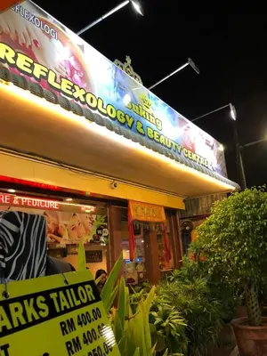 a store with a surfboard on top of it at New! Batu Ferringhi Seaview Cozy Condo, Penang in Batu Ferringhi