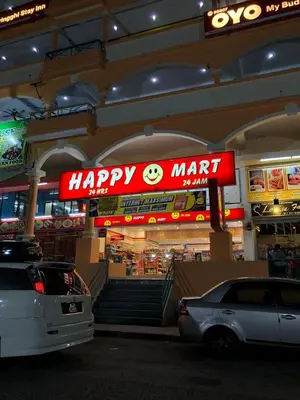 a shopping mall with a happy mart sign in front at New! Batu Ferringhi Seaview Cozy Condo, Penang in Batu Ferringhi