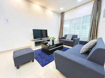 a living room with a blue couch and a tv at KawanMu House with 6 Bedrooms in Taiping