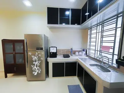 a kitchen with a refrigerator and a sink at KawanMu House with 6 Bedrooms in Taiping