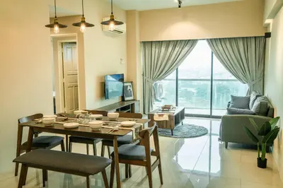 a living room with a table and chairs and a couch at Stylish River-View Apartment In Ipoh in Ipoh