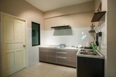 a kitchen with a sink and a counter top at Stylish River-View Apartment In Ipoh in Ipoh