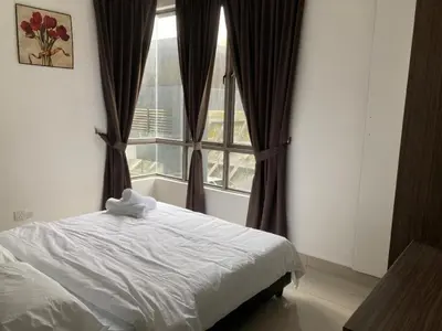 a bedroom with a bed in front of a window at SmileHome - Palas Horizon Residence 3R2B Apartment in Brinchang