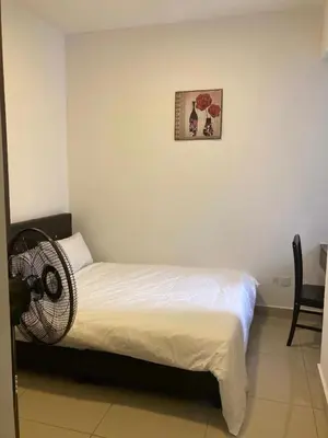 a bedroom with a bed with a fan on it at SmileHome - Palas Horizon Residence 3R2B Apartment in Brinchang