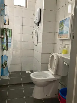 a bathroom with a toilet and a phone on the wall at SmileHome - Palas Horizon Residence 3R2B Apartment in Brinchang
