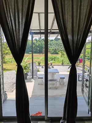 a view of a patio through a glass door at Homestay Tepi Sungai Perak in Kuala Kangsar