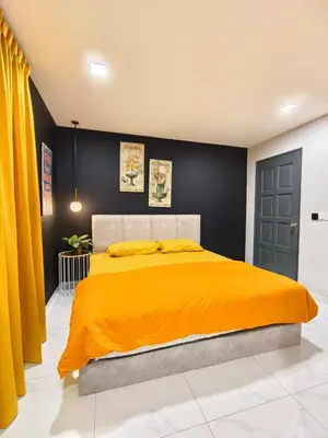 a bedroom with a large bed with an orange blanket at Ocean Private Pool Homestay Ipoh \u6d77\u6d0b\u98ce\u60c5\u6cf3\u6c60\u6c11\u5bbf 14px\uff08Wellsonhome\uff09 in Ipoh