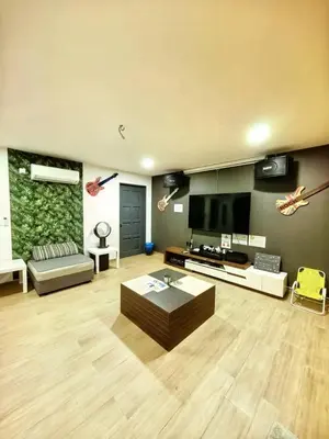 a large living room with a couch and a tv at Ocean Private Pool Homestay Ipoh \u6d77\u6d0b\u98ce\u60c5\u6cf3\u6c60\u6c11\u5bbf 14px\uff08Wellsonhome\uff09 in Ipoh