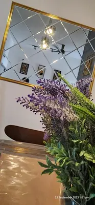 a bunch of purple flowers in a room at D'Haty Homestay in Padang Serai