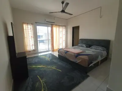 a bedroom with a bed and a ceiling fan at A&H Homestay Teluk Senangin in Segari