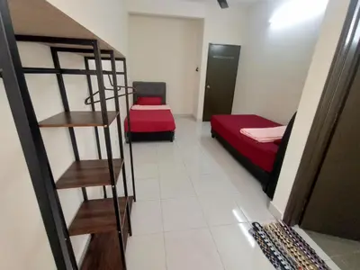 a small room with two beds and a staircase at A&H Homestay Teluk Senangin in Segari