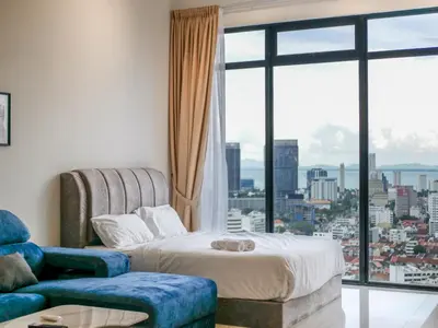 a hotel room with a bed and a large window at Beacon Executive Suite by Uptrend Home Management in George Town