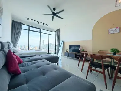 a living room with a couch and a table with a ceiling fan at Beacon Executive Suite by Uptrend Home Management in George Town