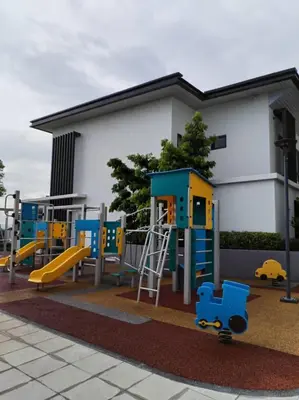 a playground with blue and yellow equipment in front of a building at Sunway Onsen 4-5pax in Kampong Batu Lapan