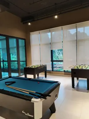 two pool tables in a room with windows at Sunway Onsen 4-5pax in Kampong Batu Lapan