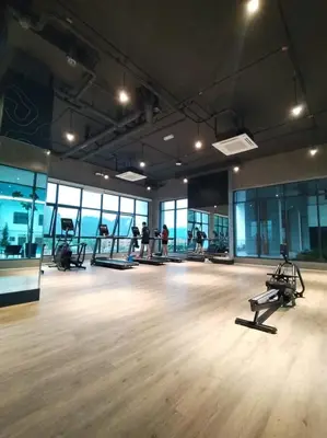 a gym with exercise equipment in a large room at Sunway Onsen 4-5pax in Kampong Batu Lapan