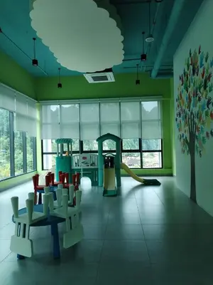 a room with a playground with chairs and a slide at Sunway Onsen 4-5pax in Kampong Batu Lapan