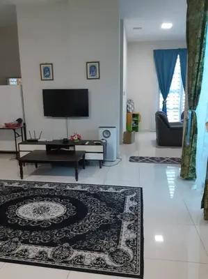 a living room with a tv and a rug at 132-A, JHC Homestay Puncak in Kampung Bota Kiri