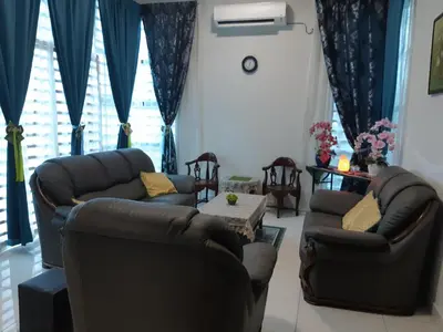 a living room with two couches and blue curtains at 132-A, JHC Homestay Puncak in Kampung Bota Kiri