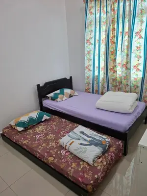 two beds sitting next to each other in a room at 132-A, JHC Homestay Puncak in Kampung Bota Kiri