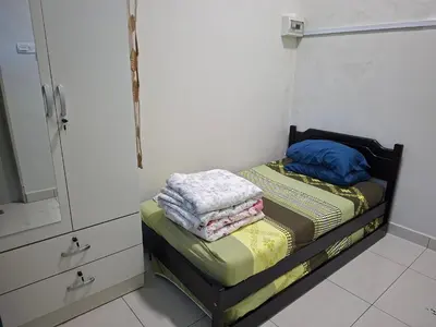 a small room with a bed and a mirror at 132-A, JHC Homestay Puncak in Kampung Bota Kiri
