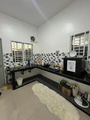 a kitchen with a counter with a microwave and a rug at Manong Kuala Kangsar Homestay Chegu Wok in Manong