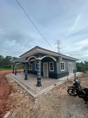a blue house with a motorcycle parked in front of it at Manong Kuala Kangsar Homestay Chegu Wok in Manong