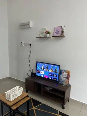 a living room with a flat screen tv on a table at Manong Kuala Kangsar Homestay Chegu Wok in Manong