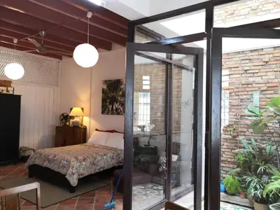 a bedroom with a bed and a glass door at Shophouse Studio in George Town