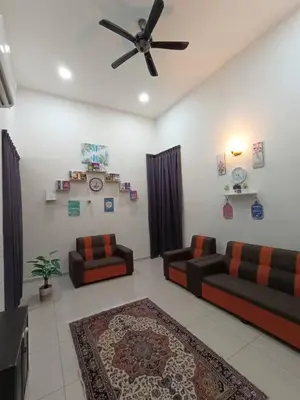 a living room with two couches and a ceiling fan at Homestay Teacher,Perak, Gerikmist in Gerik