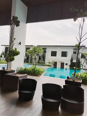 a hotel lobby with chairs and a swimming pool at Sunway Onsen Suites beautiful view in Kampong Batu Lapan