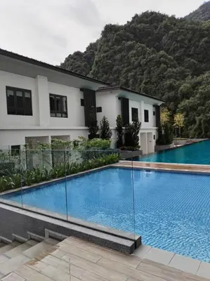 a swimming pool in front of a house at Sunway Onsen Suites beautiful view in Kampong Batu Lapan