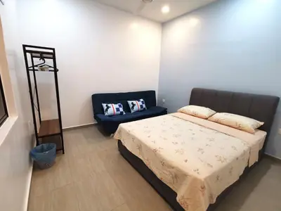 a bedroom with a bed and a blue chair at Calm in Kuala Kubu Bharu in Kuala Kubu Baharu