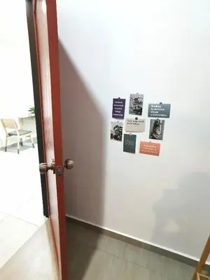 a door with a bunch of signs on a wall at Calm in Kuala Kubu Bharu in Kuala Kubu Baharu