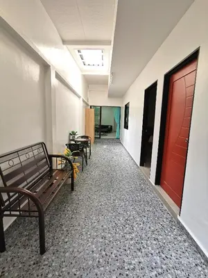 an empty hallway with benches and a red door at Calm in Kuala Kubu Bharu in Kuala Kubu Baharu