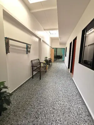 an empty hallway with benches in an office building at Calm in Kuala Kubu Bharu in Kuala Kubu Baharu