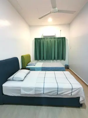 two beds in a room with green curtains at Calm in Kuala Kubu Bharu in Kuala Kubu Baharu